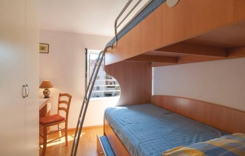 a bedroom with a bunk bed and a staircase at Direct At Sea in Postira