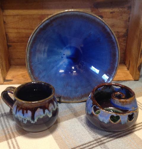 a blue bowl and two cups on a table at Mill Of Nethermill Holidays in Pennan