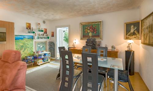 a living room with a dining room table and chairs at Ferienhaus Haus Herzog in Titisee-Neustadt