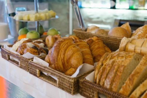 a bunch of different types of bread and pastries on a table at Hotel Museu Llegendes de Girona in Girona