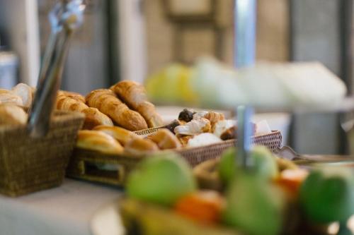 a bunch of different types of donuts on a table at Hotel Museu Llegendes de Girona in Girona