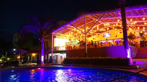 a building with a swimming pool at night at Hotel Posada Virreyes in Guadalajara