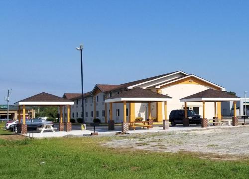a building with cars parked in a parking lot at Super 8 by Wyndham Franklin in Franklin