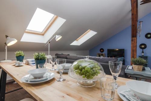 a dining room table with a bowl of grapes on it at APT with sunny garden Prague by Michal&Friends in Prague
