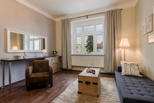 a living room with a couch and a chair at APT with sunny garden Prague by Michal&Friends in Prague
