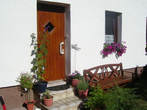 a wooden door with a bench and potted plants at Ferienwohnung "Lützowhof" in Lübeck