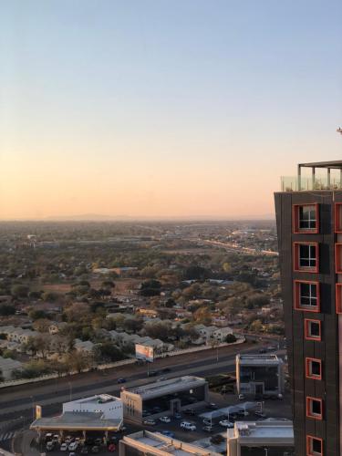 an aerial view of a city with a tall building at Urban Awe Apartment- iTowers 18th Floor in Gaborone