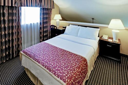 a hotel room with a large bed and a window at Hawthorn Extended Stay by Wyndham Dayton in Dayton