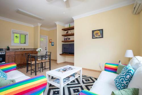 a living room with a couch and a table at Sir Charles Guest House in South Palmetto Point