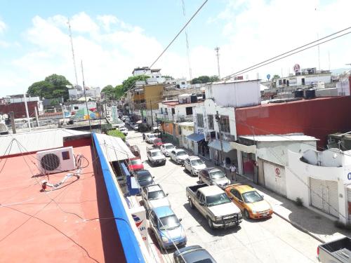a city street with cars parked in a parking lot at Hotel Naj Kin in Palenque