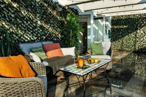a patio with two chairs and a table with pillows at Qult - Up in the Sky in Bucharest