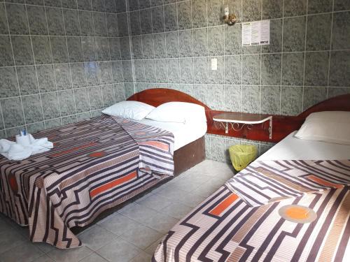 a room with two beds in a room at Hotel Naj Kin in Palenque