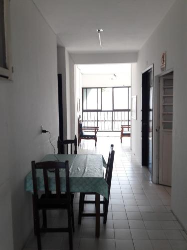 a dining room with a table and chairs and a window at Hotel Naj Kin in Palenque