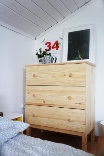 a wooden dresser in a bedroom with a bed at RowerowyFun in Nowy Sącz