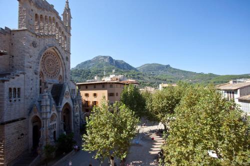 a view of a city with trees and a building at Hotel la Vila in Sóller
