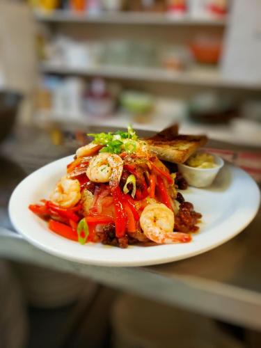 a plate of food with shrimp and toast on a counter at Coronet Hotel in Prince Albert