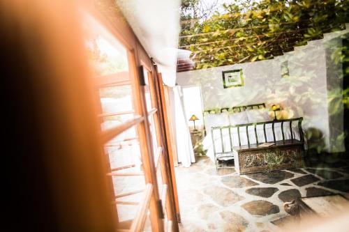 an open door leading to a room with a bench at Korakia Pensione in Palm Springs