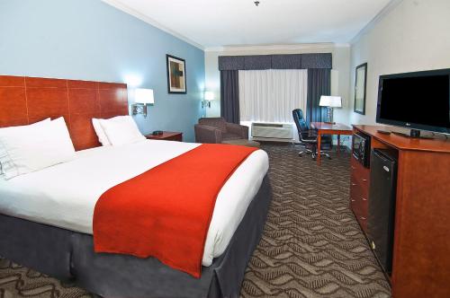 a hotel room with a bed and a flat screen tv at Holiday Inn Express Hotel and Suites Lake Charles, an IHG Hotel in Lake Charles