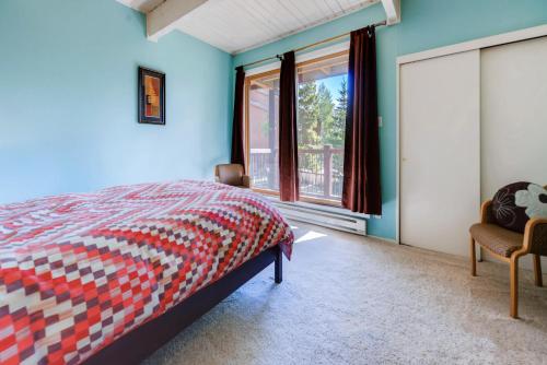 a bedroom with blue walls and a bed and a window at One-Bedroom Sundowner Condo T4 in Breckenridge