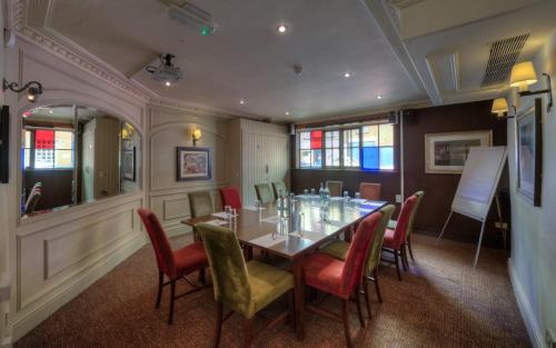 a dining room with a table and chairs at Dog & Partridge by Chef & Brewer Collection in Tutbury