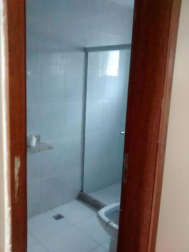 a bathroom with a glass shower with a sink at Apartamento Triplex in Rio de Janeiro