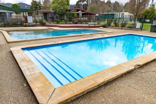 a large swimming pool with blue water at BIG4 Breeze Holiday Parks - Eildon in Eildon