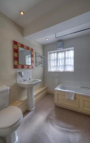 a bathroom with a toilet and a sink and a tub at Dog & Partridge by Chef & Brewer Collection in Tutbury