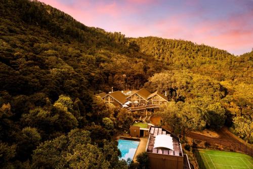 an aerial view of a house in the mountains at Grand Mercure Puka Park Resort in Pauanui