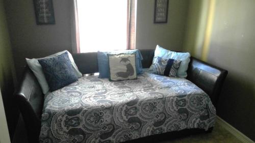 a bed with a blanket and pillows on it at 107 Pike on Oceanside in South Padre Island