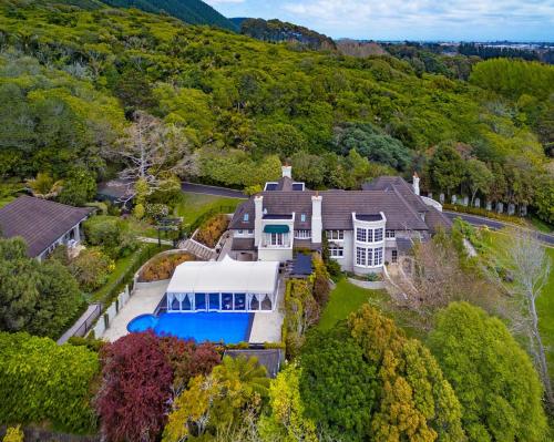 an aerial view of a large white house with a pool at Greenmantle Estate Hotel in Paraparaumu