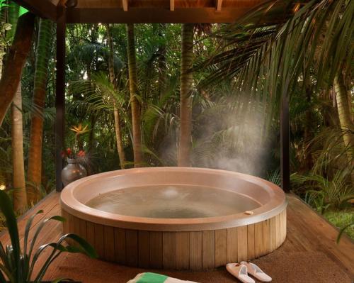 a hot tub in the middle of a jungle at Greenmantle Estate Hotel in Paraparaumu
