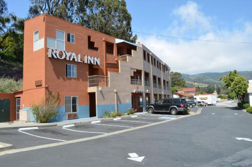 a building with a car parked in a parking lot at Royal Inn in South San Francisco
