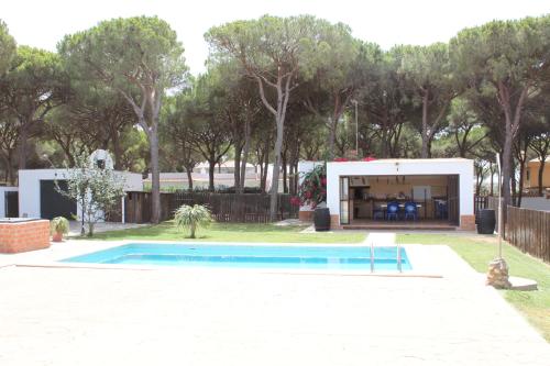 a swimming pool in a yard next to a house at Villa Mayorazgo-Solo Familias in Conil de la Frontera