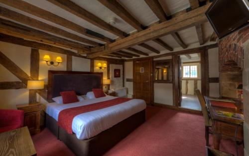 a bedroom with a bed and a television in a room at Dog & Partridge by Chef & Brewer Collection in Tutbury