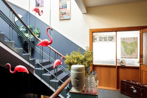 a room with pink flamingos on the stairs at Alabama Hotel Hobart in Hobart