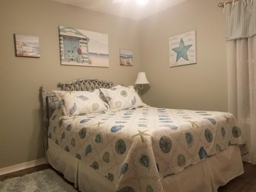 a bedroom with a bed with a comforter and pillows at Destin Daydream in Destin