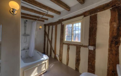 a bathroom with a toilet and a window in it at Dog & Partridge by Chef & Brewer Collection in Tutbury