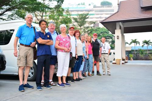 a group of people standing in front of a van at The Choice Hotel - Adults Only in Bangkok