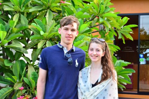 a young man and a woman posing for a picture at The Choice Hotel - Adults Only in Bangkok