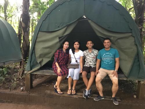 a group of people sitting in a tent at Tegal Dukuh Camp in Tegalalang