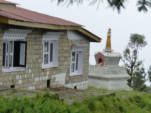 a small building with a statue on top of it at Lukla Airport Resort Lukla in Lukla