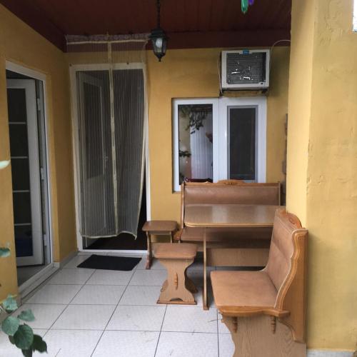 a porch with a bench and a table and chairs at Dom v Arkadii in Odesa