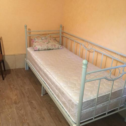 a bed with a metal frame and a pillow on it at Dom v Arkadii in Odesa