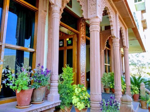 a bunch of potted plants sitting on a building at Teerth Palace Pushkar in Pushkar