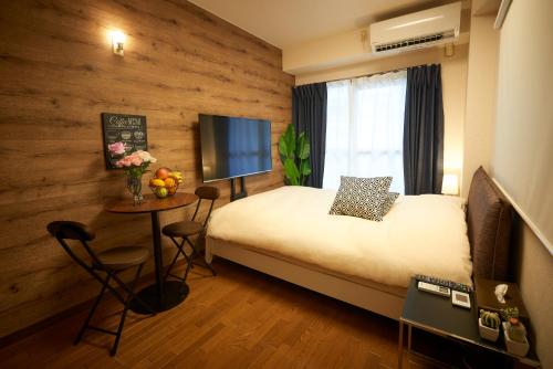 Postel nebo postele na pokoji v ubytování Garden Otsuka