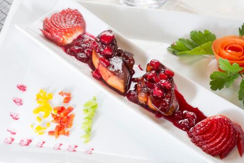 a white plate topped with different types of food at Logis Le Printemps Hôtel Restaurant - Montélimar in Montélimar