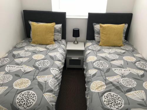 a bedroom with two twin beds and a table at Eastbourne, Sovereign Harbour Holiday Home in Eastbourne