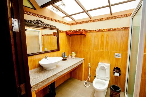 a bathroom with a sink and a toilet and a mirror at Paradise Pearl Bungalows in Phi Phi Don