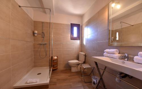 a bathroom with a shower and a sink and a toilet at Hotel Cyrnea in Calvi