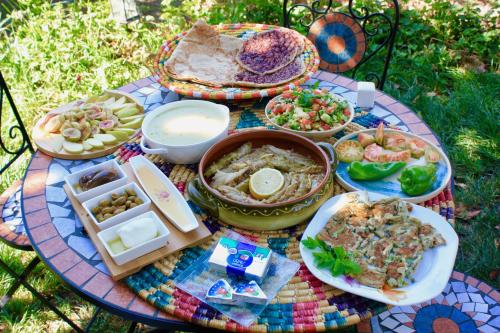 a table with a bunch of food on it at Zimer Al-Bayt in Mas'ade